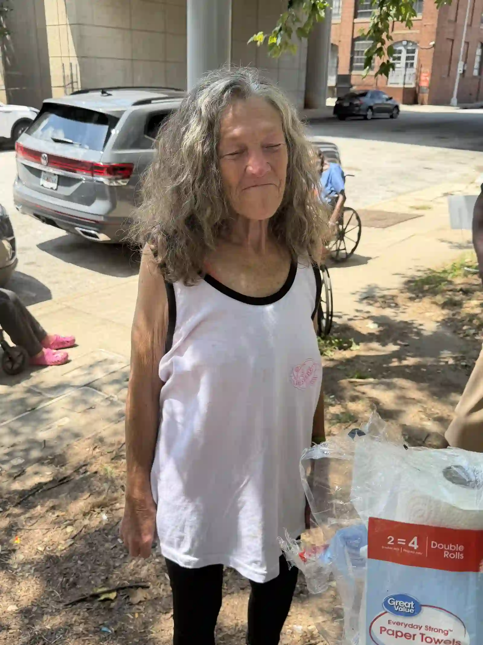 Woman standing on the sidewalk after receiving outreach supplies