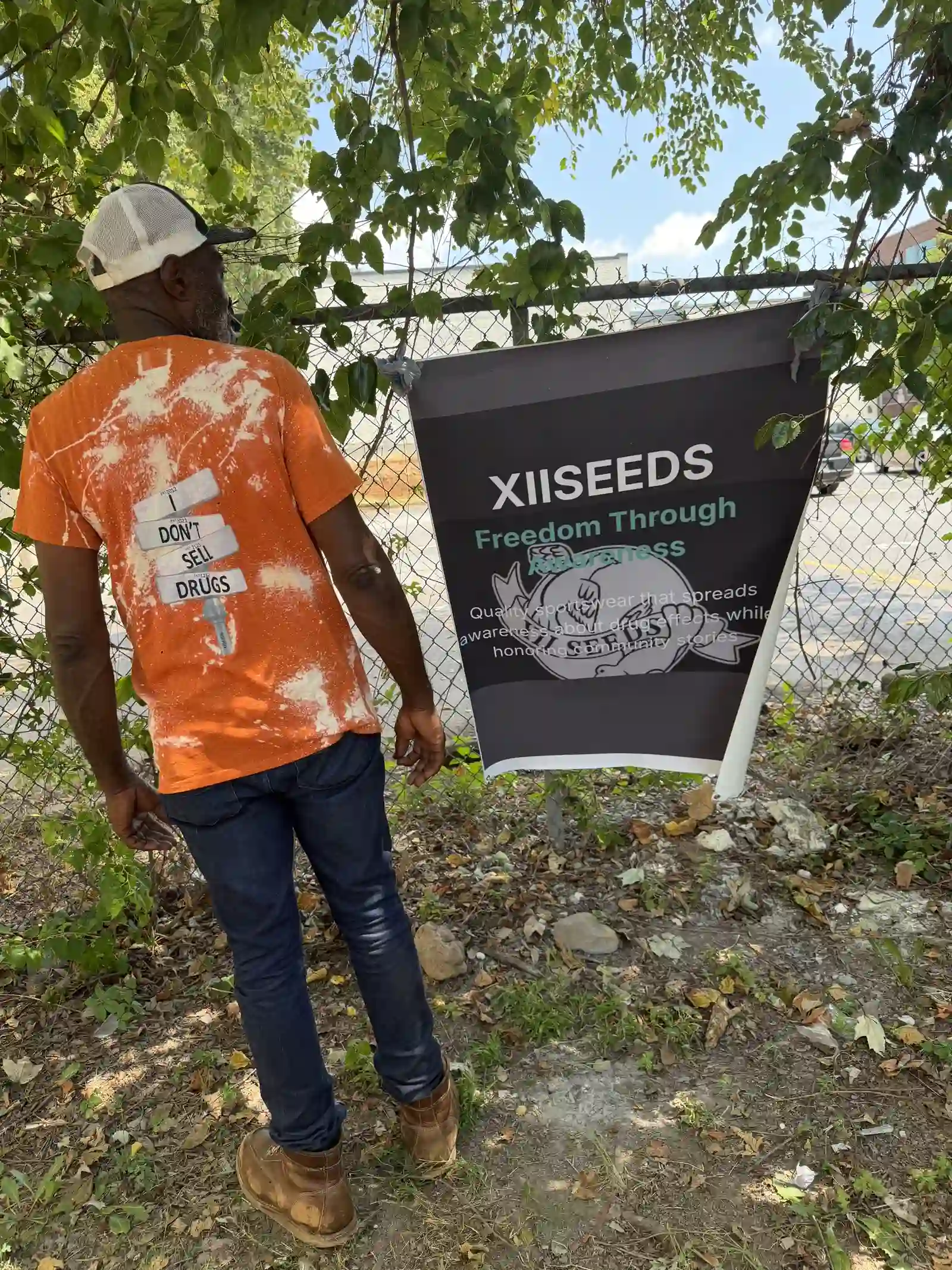 Back of an orange tie-dye XIISEEDS shirt