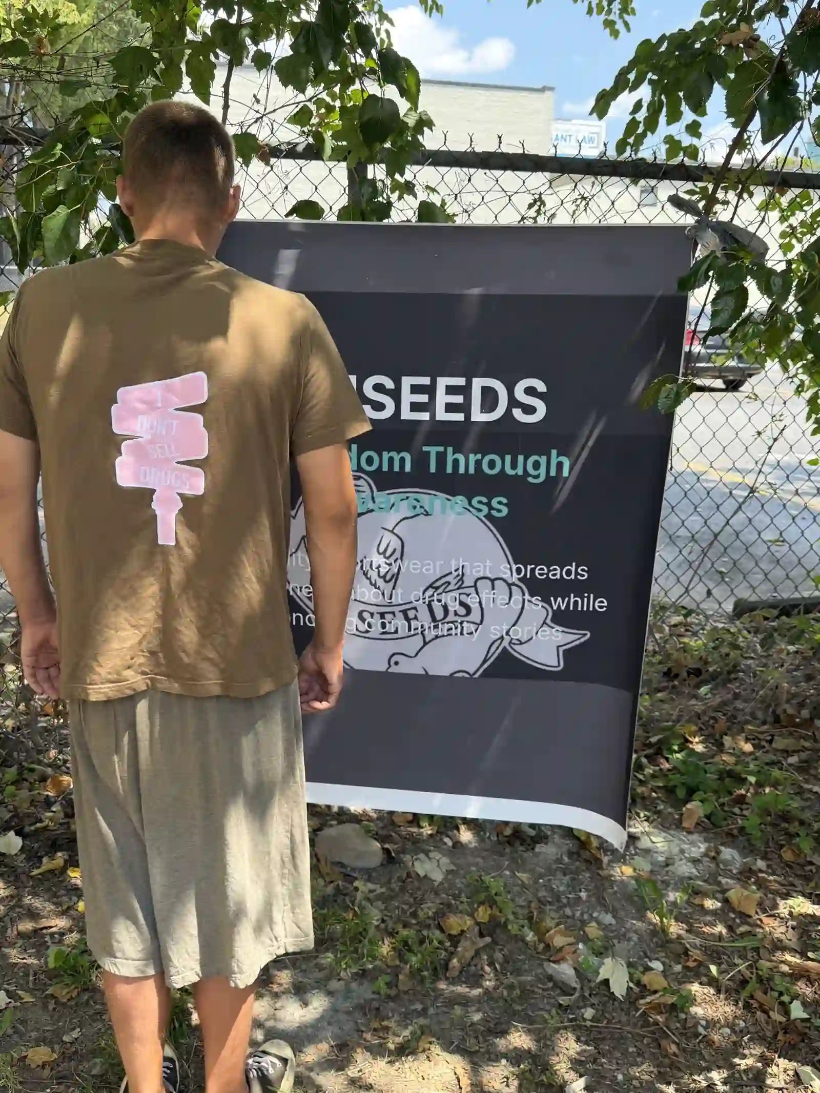Back of an olive XIISEEDS tee showing the seed logo
