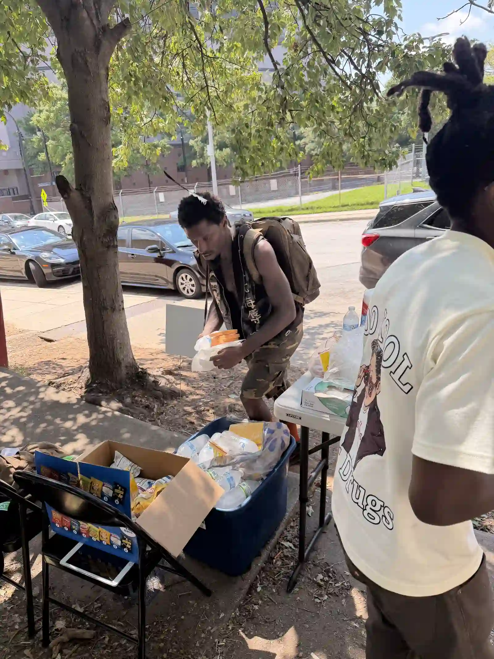 Volunteer packing a box of supplies at the outreach table