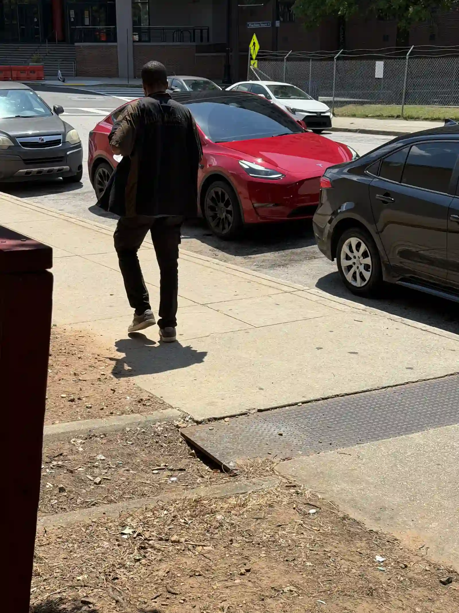 Man walking toward parked cars after the outreach event