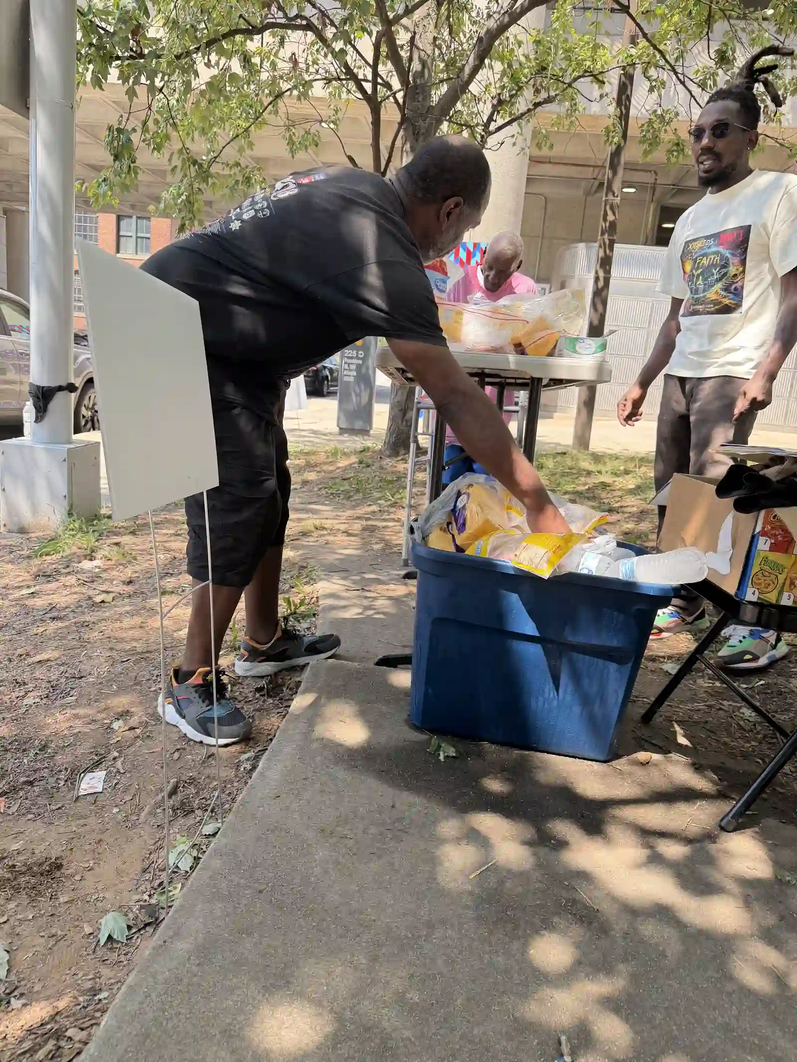 Volunteer sorting through a bin of supplies