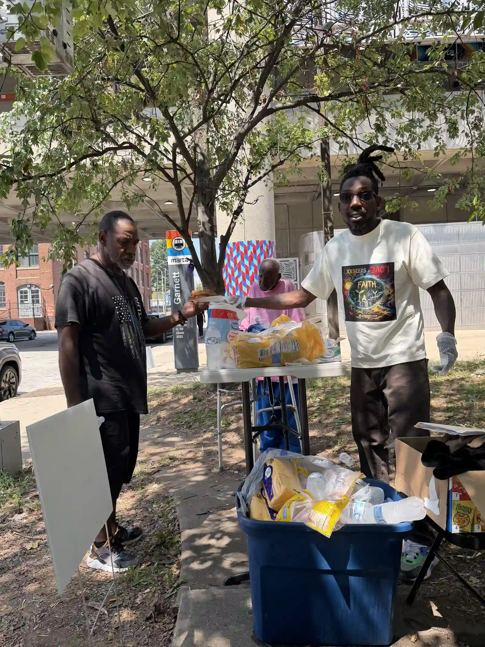 Volunteers organizing supplies at the outreach table