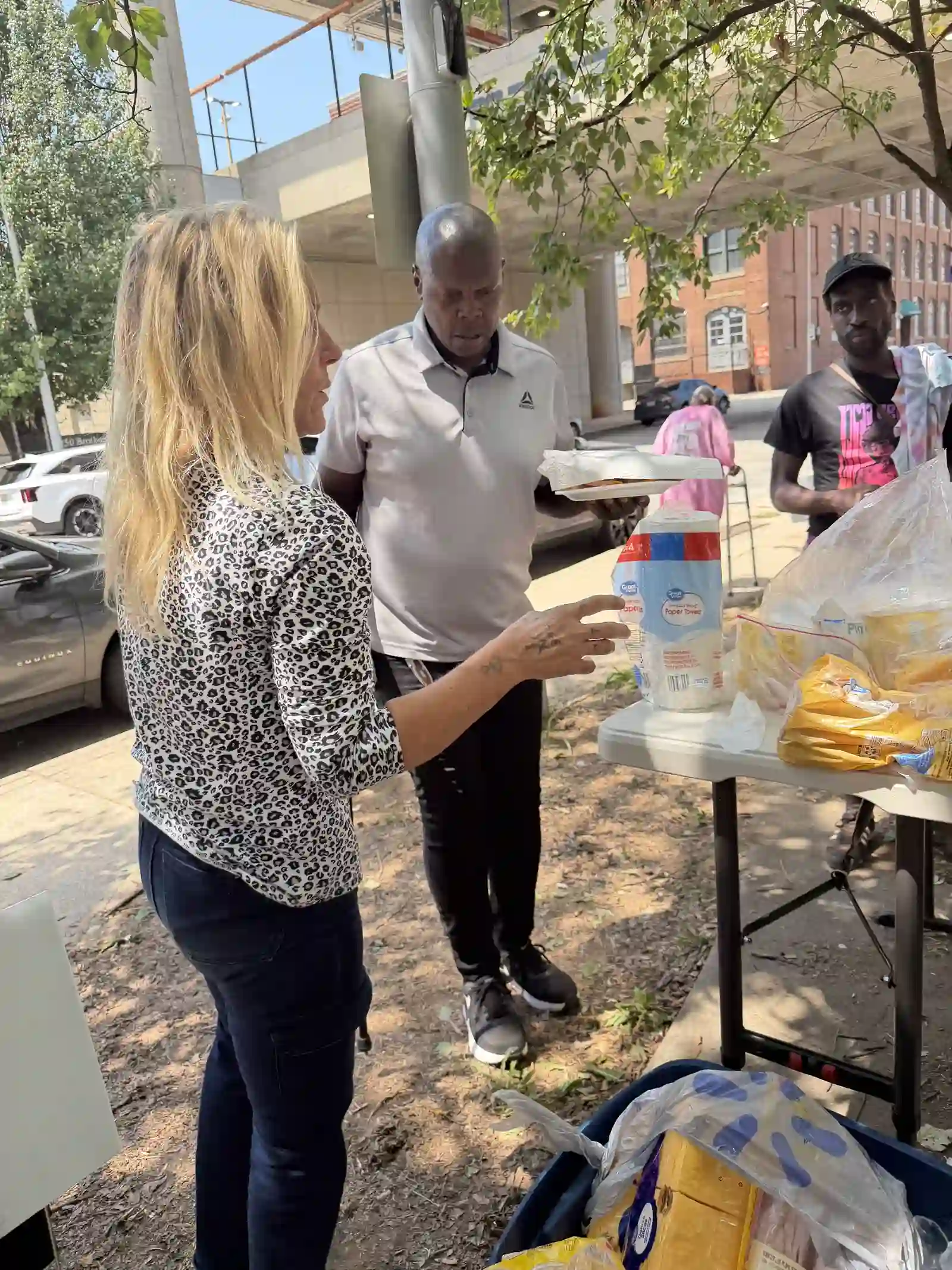 Volunteer handing supplies to a community member