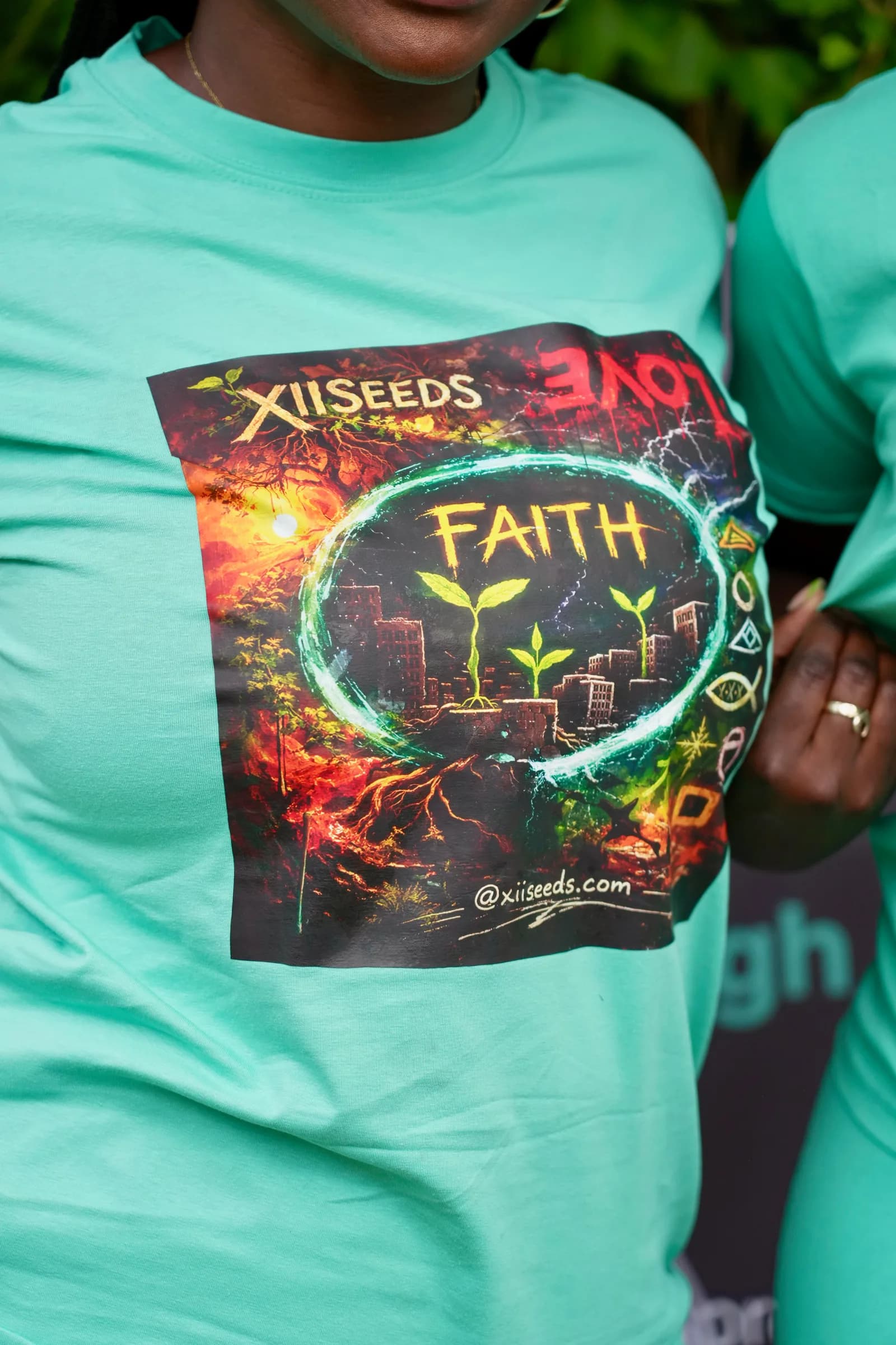 Woman wearing a mint XII SEEDS FAITH graphic tee