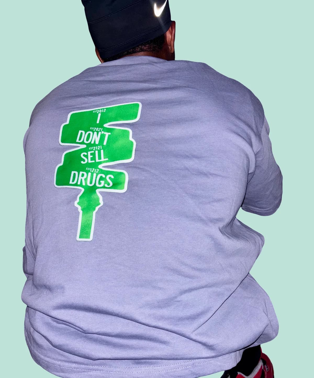 Close-up of the green 'I Don't Sell Drugs' street-sign graphic on a gray XII SEEDS tee